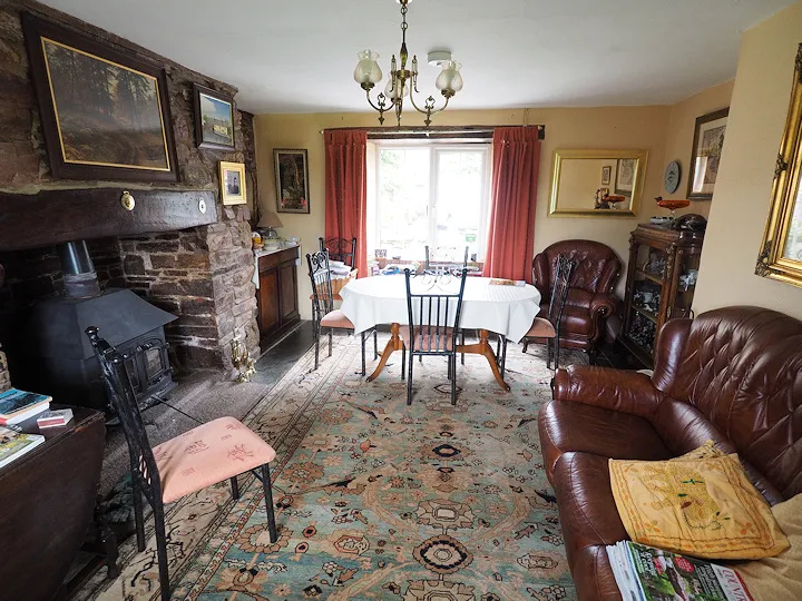 The flagstoned breakfast room at Callisham Farm, with a wooden table set for guests
