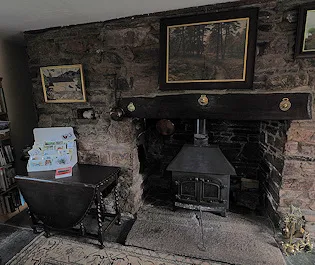 The woodburner and armchairs in the breakfast room